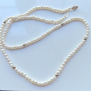 14k solid gold and Pearl necklace. 24 inch long.